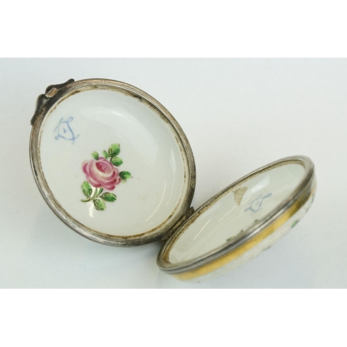 256 - Continental ceramic and white metal circular trinket box with hand-painted roses to the outside and ... 