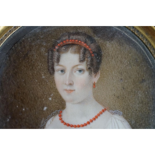 156 - 19th century English School, portrait miniature of a young woman wearing a coral headband and neckla... 