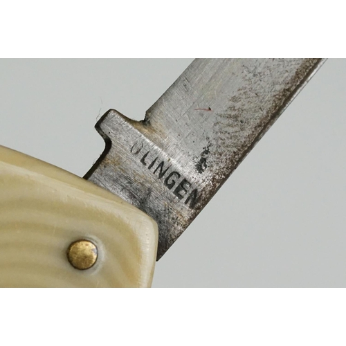 157 - A fine quality Continental twin bladed pen knife stamped INOX, Solingen, the brass sides embossed wi... 