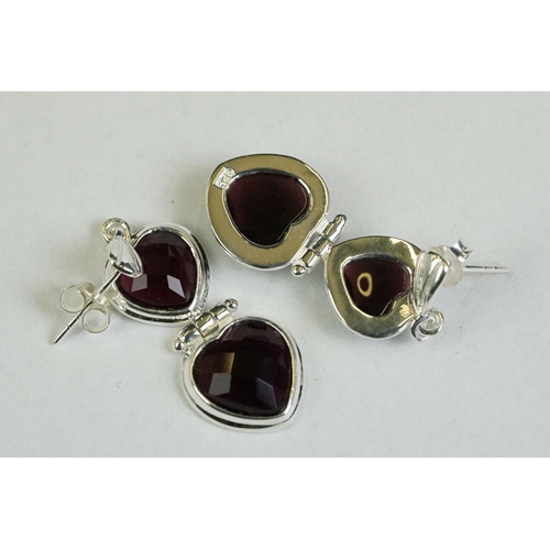 177 - A pair of silver heart shaped amethyst drop earrings