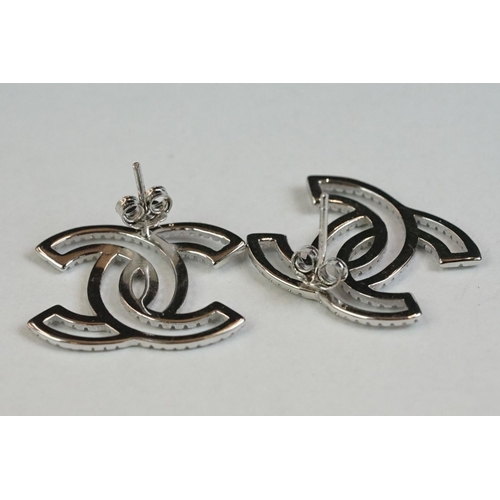 179 - A pair of silver and CZ designer style stud earrings