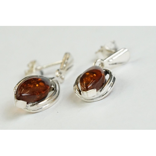 182 - A pair of silver and amber drop earrings