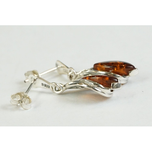 182 - A pair of silver and amber drop earrings