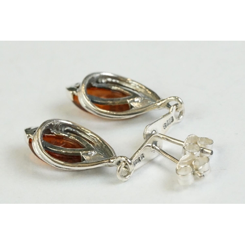 182 - A pair of silver and amber drop earrings