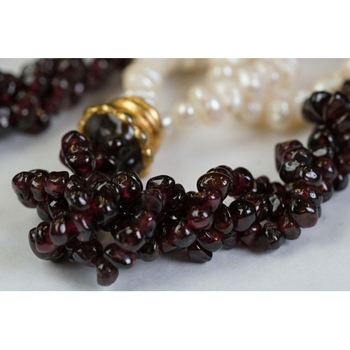 189 - A garnet and natural pearl necklace together with a white metal marcasite brooch in the form of scal... 