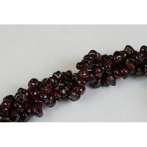 189 - A garnet and natural pearl necklace together with a white metal marcasite brooch in the form of scal... 