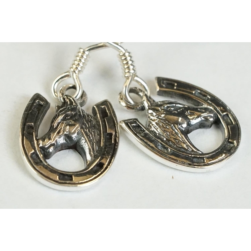 191 - A pair of silver horseshoe drop earrings