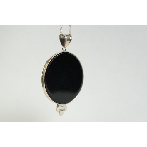 193 - A silver and onyx pendant necklace in the form of a lady with a cabouchon ruby