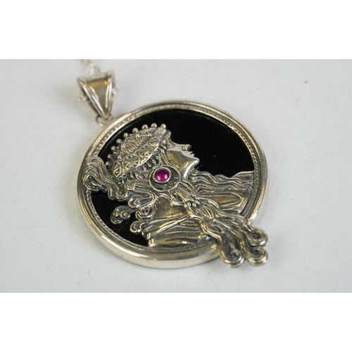 193 - A silver and onyx pendant necklace in the form of a lady with a cabouchon ruby