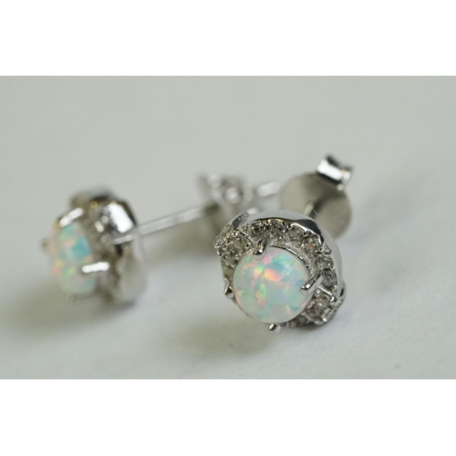 194 - A pair of silver CZ and opal panelled stud earrings