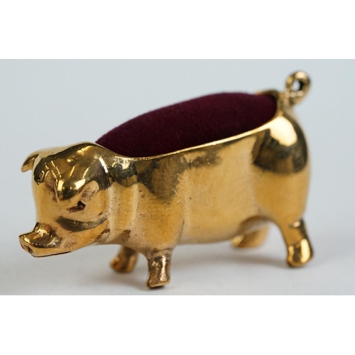 196 - A brass cased pig pincushion