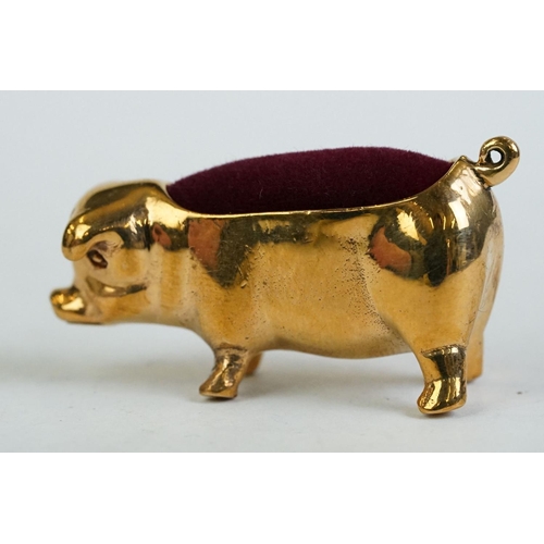 196 - A brass cased pig pincushion