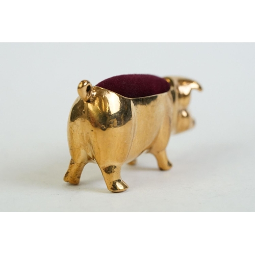 196 - A brass cased pig pincushion