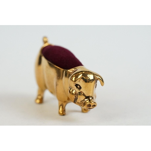 196 - A brass cased pig pincushion