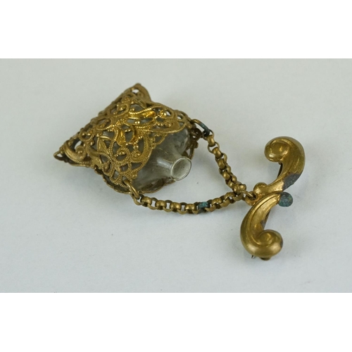 260 - 19th century miniature scent bottle contained within pierced cover suspended from a bar brooch, hing... 