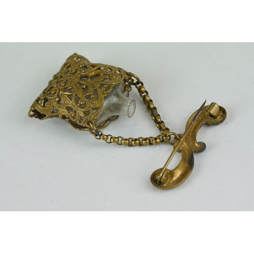 260 - 19th century miniature scent bottle contained within pierced cover suspended from a bar brooch, hing... 