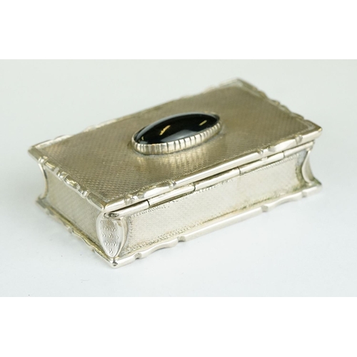 270 - George IV silver snuff box, the engine turned hinged lid set with black onyx oval cabochon, cast sty... 