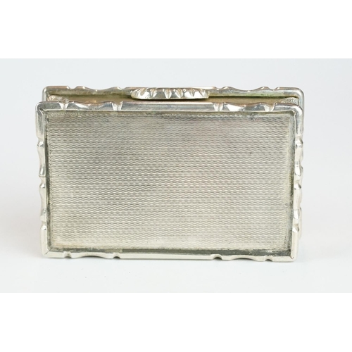 270 - George IV silver snuff box, the engine turned hinged lid set with black onyx oval cabochon, cast sty... 