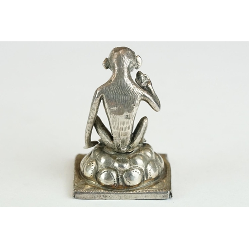 278 - Continental white metal figurine modelled as a squatting monkey, red glass eyes, height approx 3.5cm... 