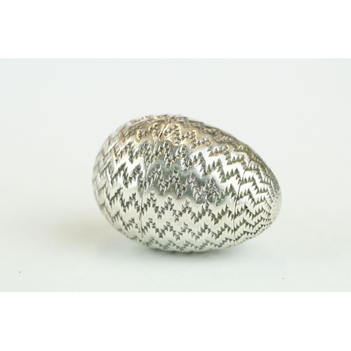 283 - Early 18th century German white metal pomander modelled as an egg with engraved zig-zag decoration, ... 