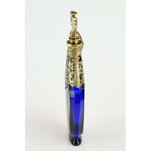 289 - 18th century blue glass gilt scent bottle, faceted hourglass body raised on foot, pierced gilt colla... 