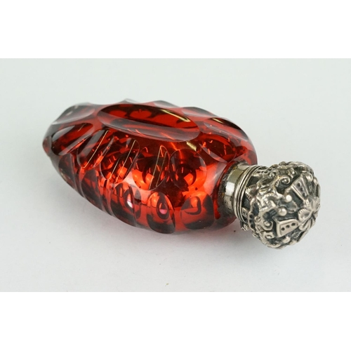 292 - 19th century red mercury glass scent bottle, white metal hinged lid with repoussé decoration, openin... 