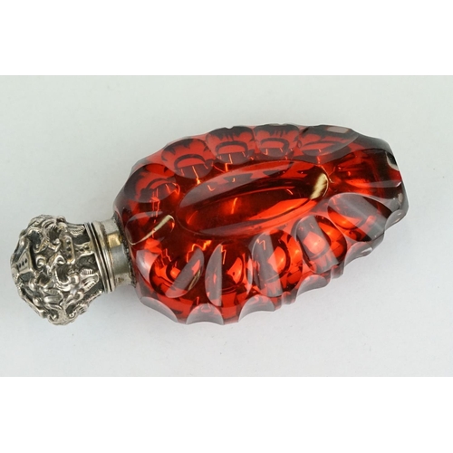 292 - 19th century red mercury glass scent bottle, white metal hinged lid with repoussé decoration, openin... 