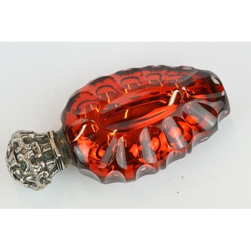 292 - 19th century red mercury glass scent bottle, white metal hinged lid with repoussé decoration, openin... 