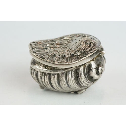 320 - Unmarked silver snuff box modelled as a stylised shell, three cast scroll feet, cast hinged lid, gil... 