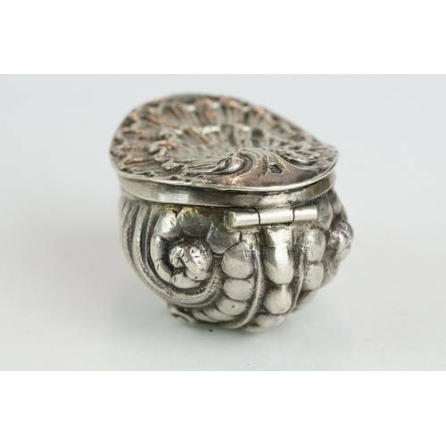 320 - Unmarked silver snuff box modelled as a stylised shell, three cast scroll feet, cast hinged lid, gil... 