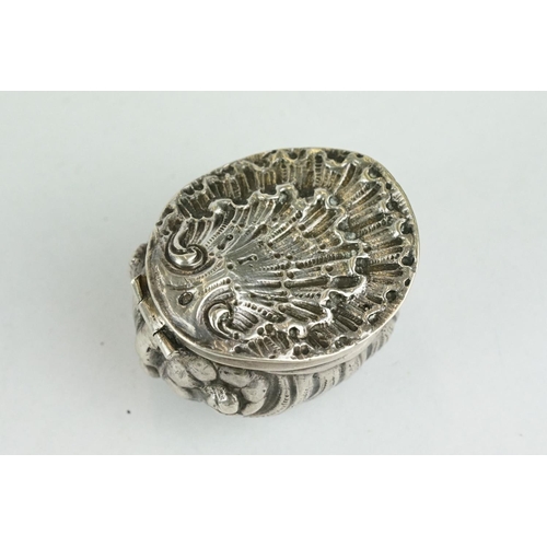 320 - Unmarked silver snuff box modelled as a stylised shell, three cast scroll feet, cast hinged lid, gil... 