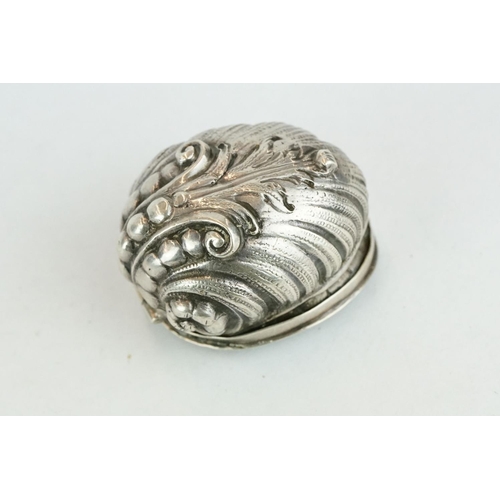 320 - Unmarked silver snuff box modelled as a stylised shell, three cast scroll feet, cast hinged lid, gil... 