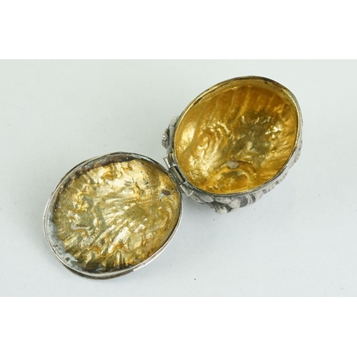 320 - Unmarked silver snuff box modelled as a stylised shell, three cast scroll feet, cast hinged lid, gil... 