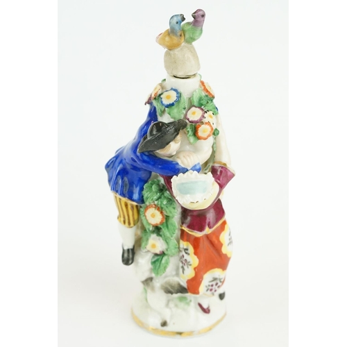 322 - Girl in Swing scent bottle depicting a courting couple amongst a flower bower with another boy and d... 