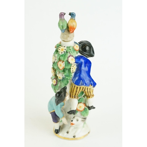 322 - Girl in Swing scent bottle depicting a courting couple amongst a flower bower with another boy and d... 