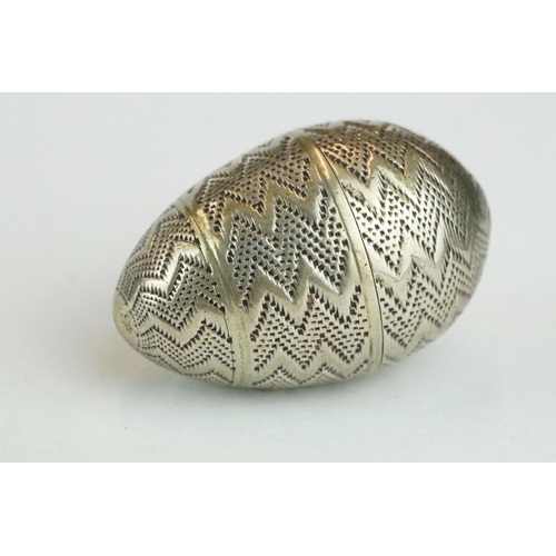 330 - White metal pomander of egg form, punched zig zag decoration, height approx 4cm

Provenance: from th... 