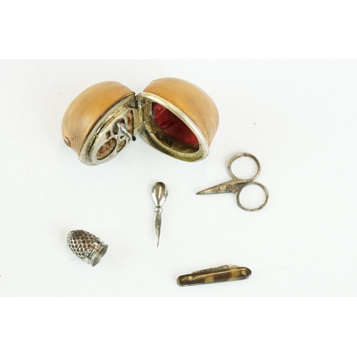 334 - Late 19th century miniature etui contained within a hazlenut, containing miniature scissors, thimble... 