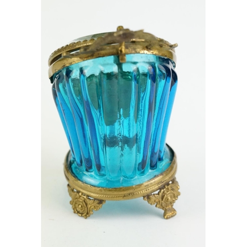 336 - Late 19th century blue glass and brass pocket watch display case, raised on four cast feet, rose bud... 