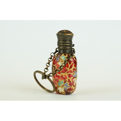 339 - Late 19th century cranberry glass scent bottle with finger chain, circa 1880, with hand painted enam... 