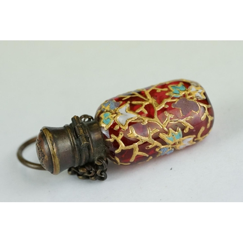 339 - Late 19th century cranberry glass scent bottle with finger chain, circa 1880, with hand painted enam... 