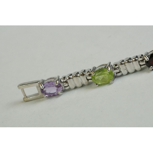 346 - A silver bracelet set with amethyst, peridot, ruby, aquamarine etc