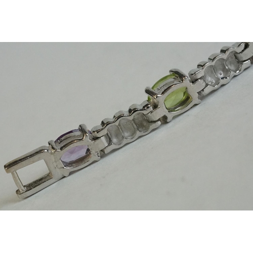 346 - A silver bracelet set with amethyst, peridot, ruby, aquamarine etc