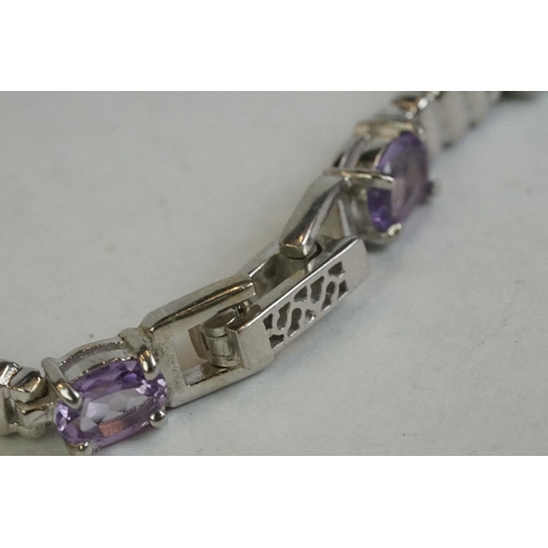 346 - A silver bracelet set with amethyst, peridot, ruby, aquamarine etc