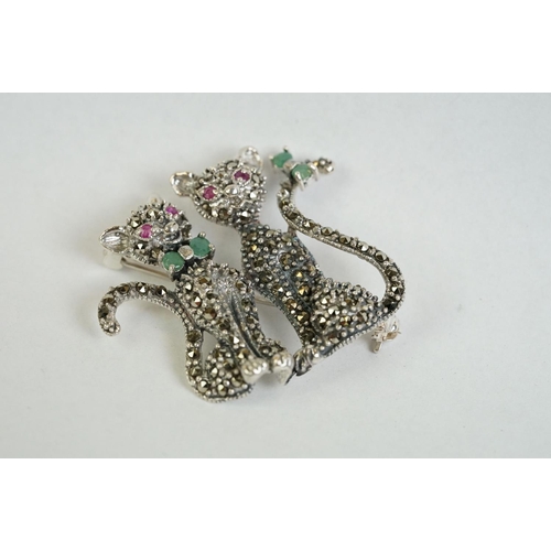 359 - A silver and marcasite cat brooch set with ruby eyes and emerald bow tie