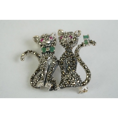 359 - A silver and marcasite cat brooch set with ruby eyes and emerald bow tie