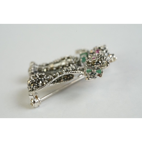 359 - A silver and marcasite cat brooch set with ruby eyes and emerald bow tie