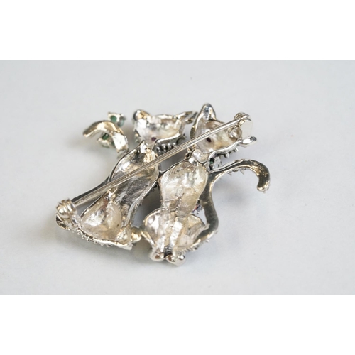 359 - A silver and marcasite cat brooch set with ruby eyes and emerald bow tie