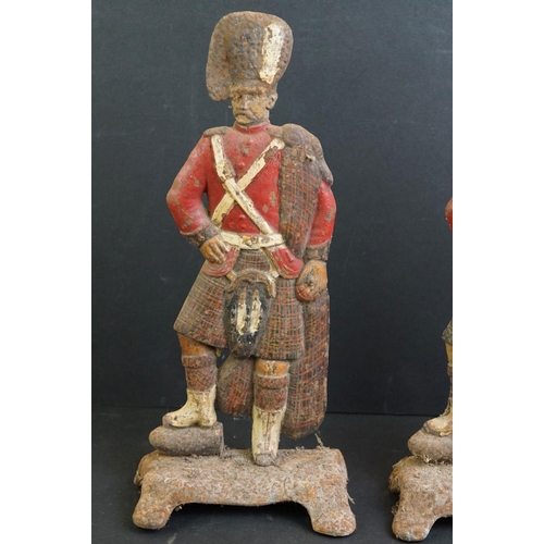 477 - Pair of cast iron painted door stops modelled as Highland Regiment soldiers, 30cm high, together wit... 