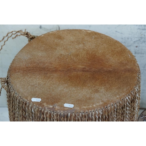 490 - African cowhide bongo drum with twine fastenings, 47cm high, together with a small African beadwork ... 