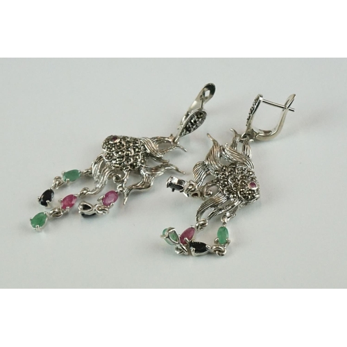 361 - A pair of silver angle fish earrings set with marcasites, ruby, sapphire and emeralds